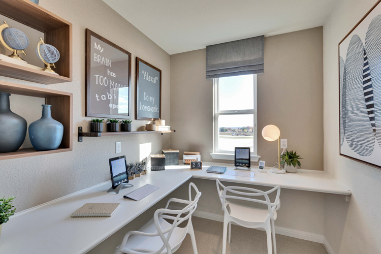 A room with a desk and computer.