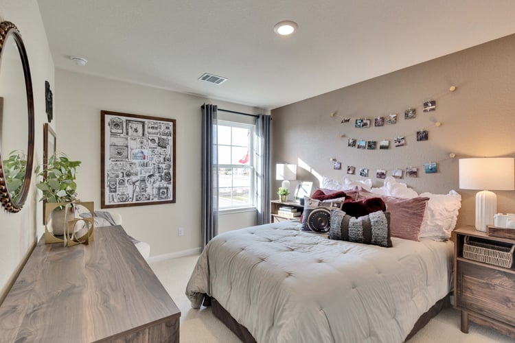 A bedroom with a bed and a desk.