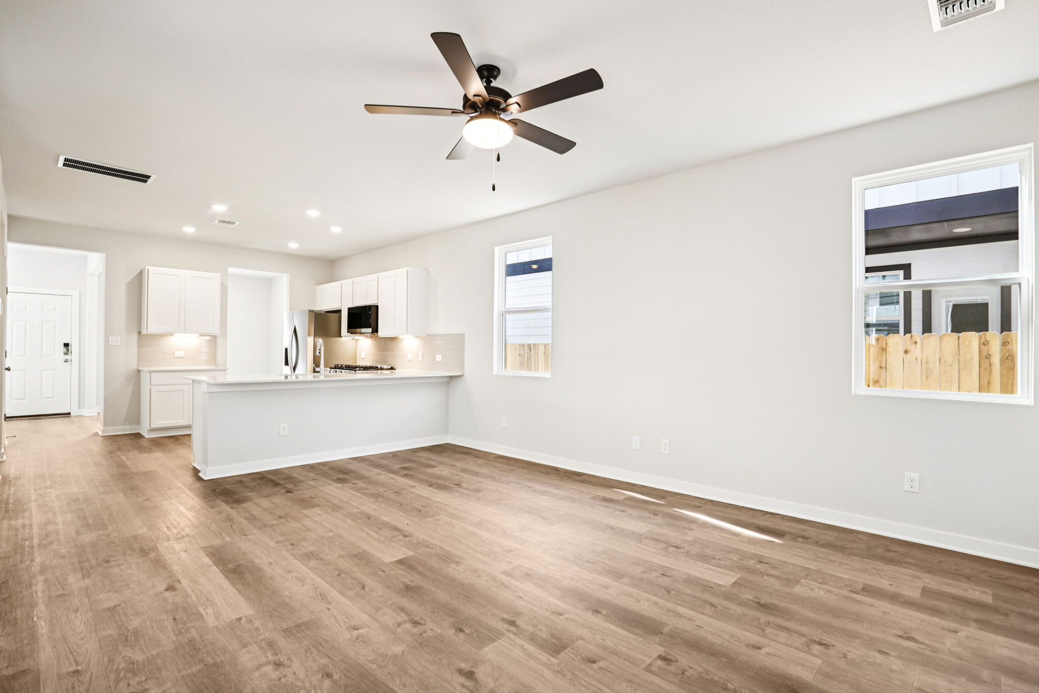 A kitchen with a wood floor.