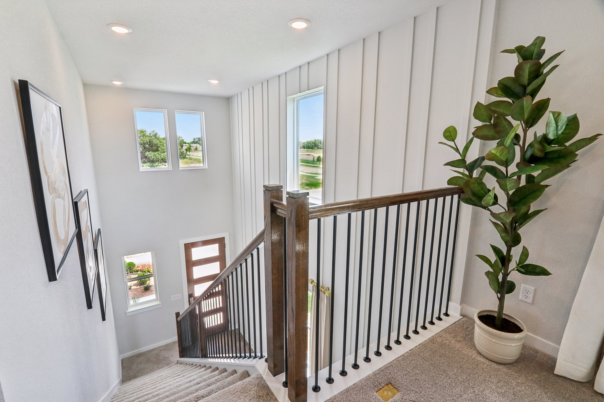 A room with a plant and a railing.