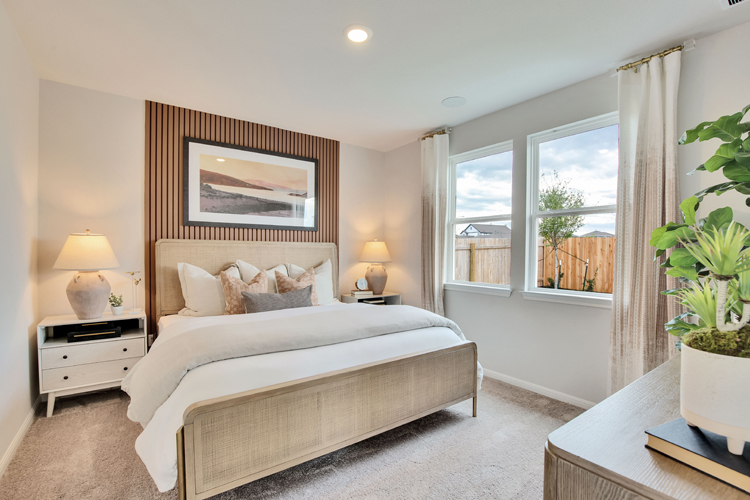 A bedroom with a large window.