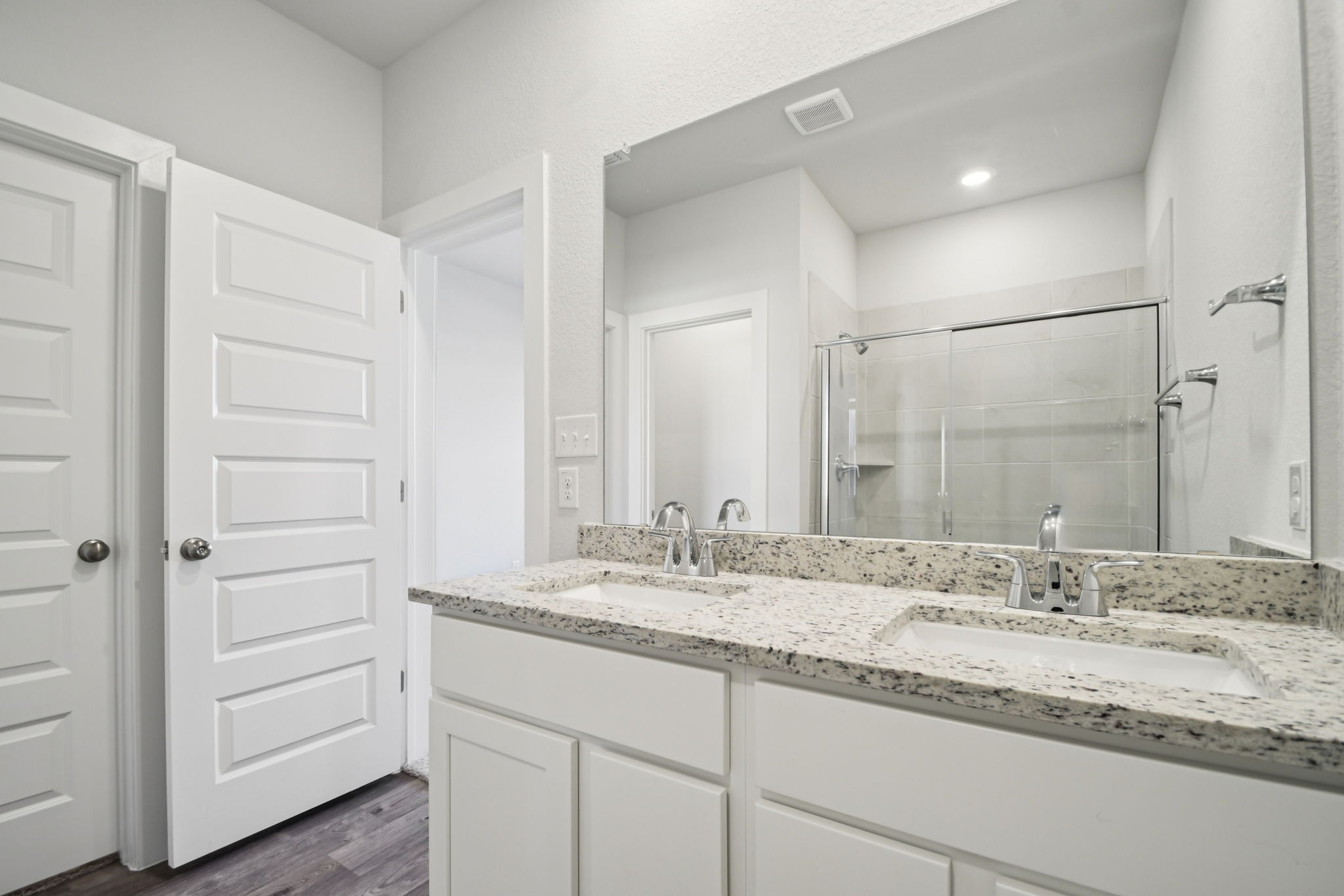 A bathroom with a large mirror.