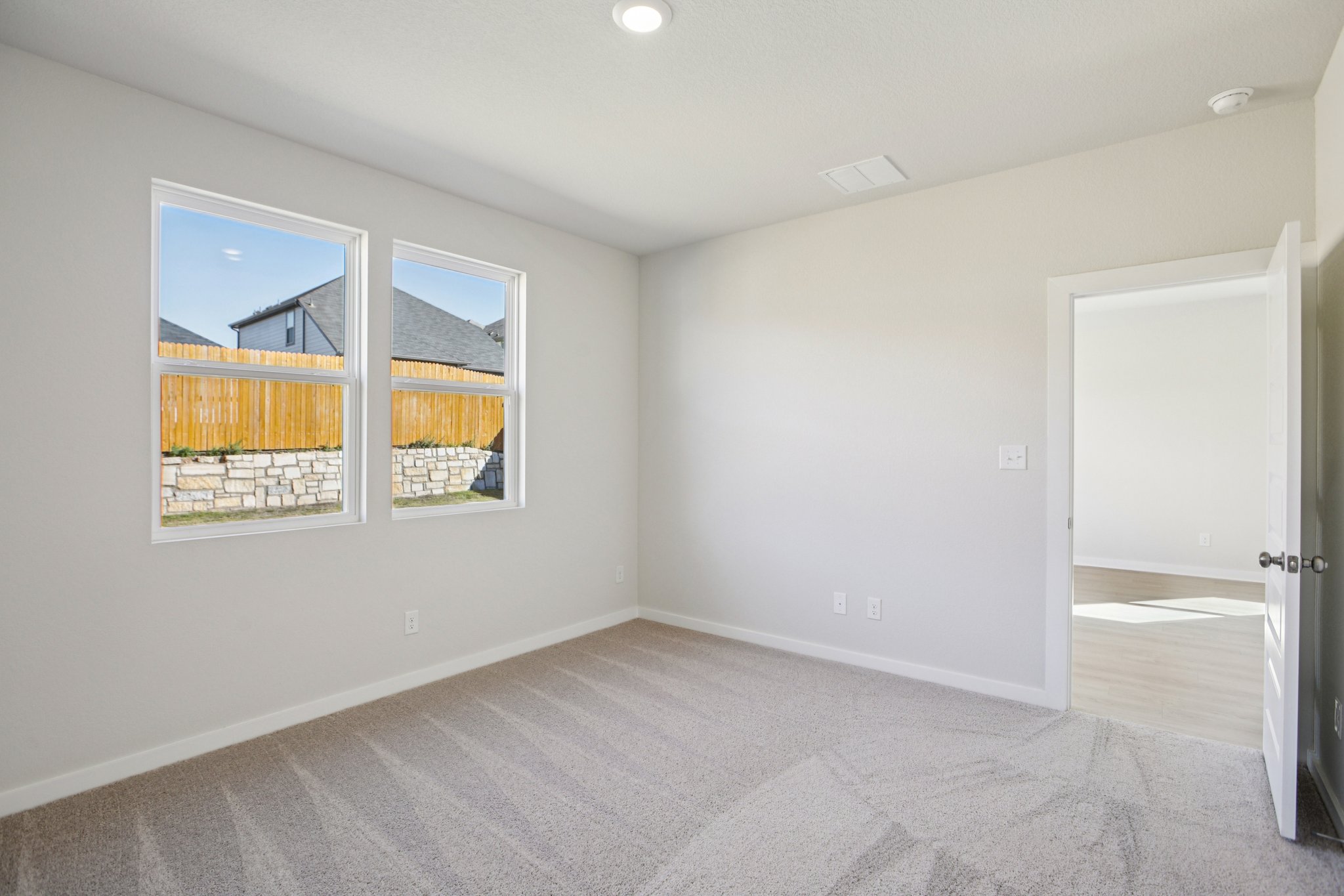 A room with a window and a door.