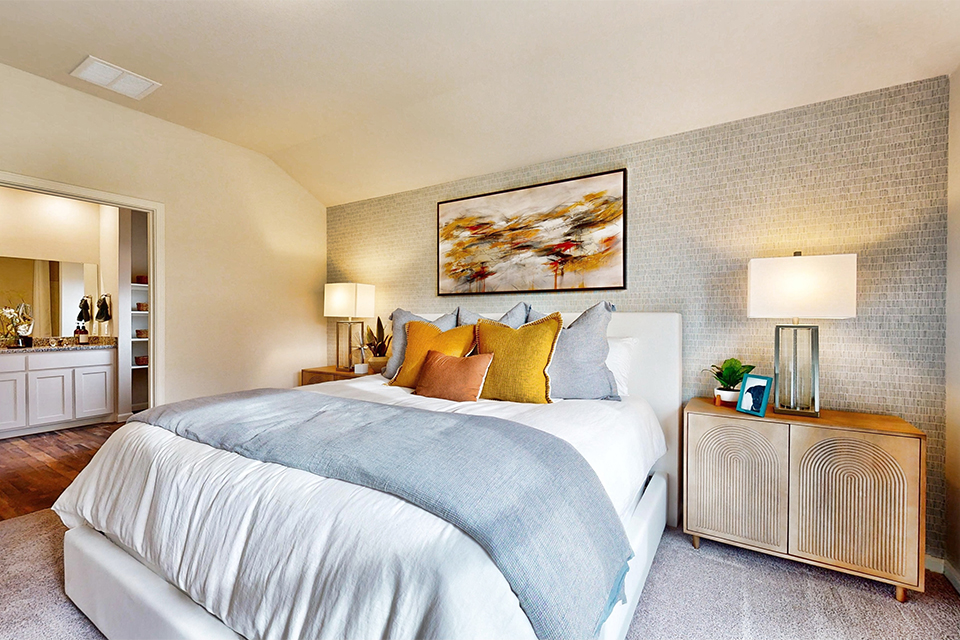 A bed with a white bed spread.