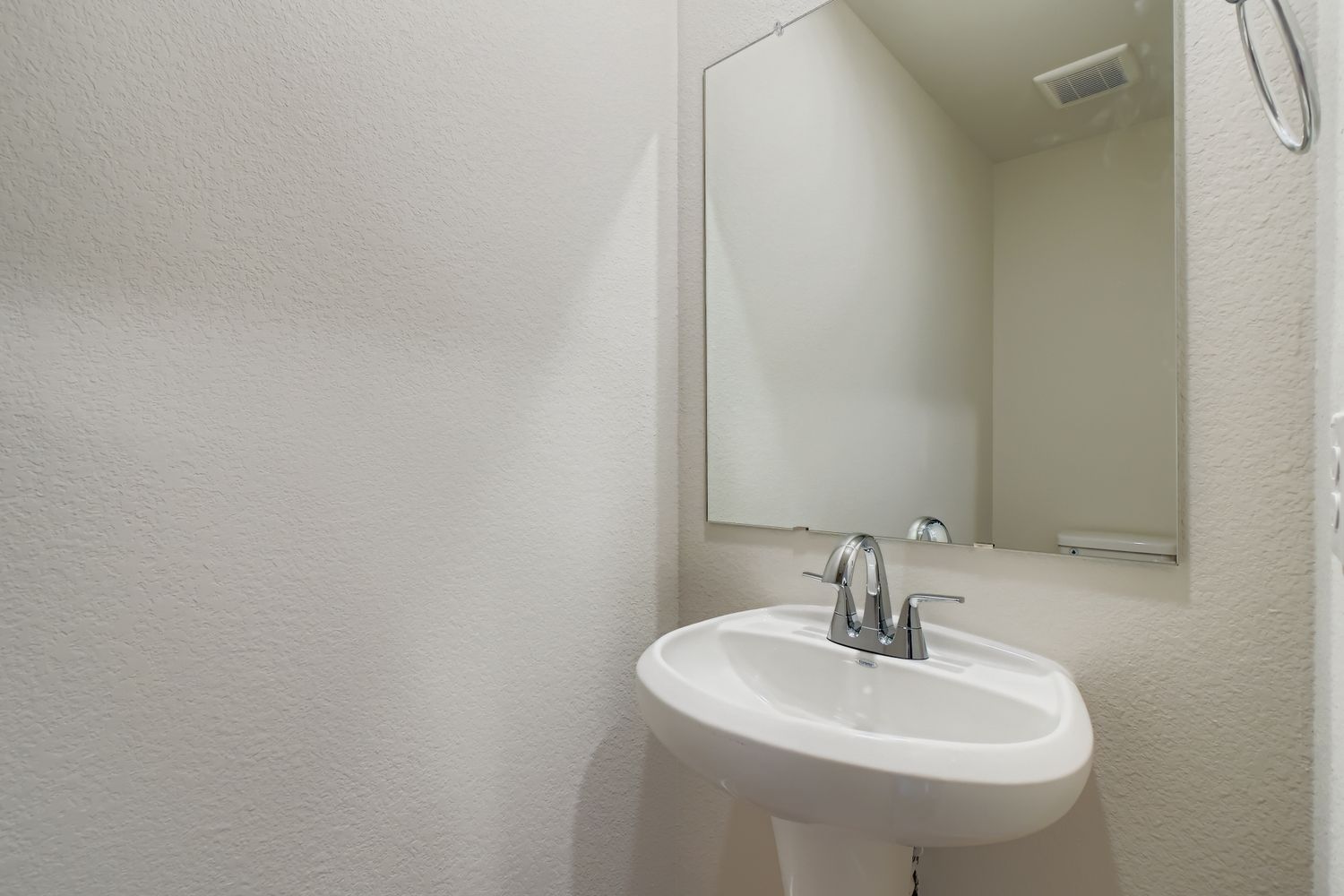 A bathroom with a large mirror.