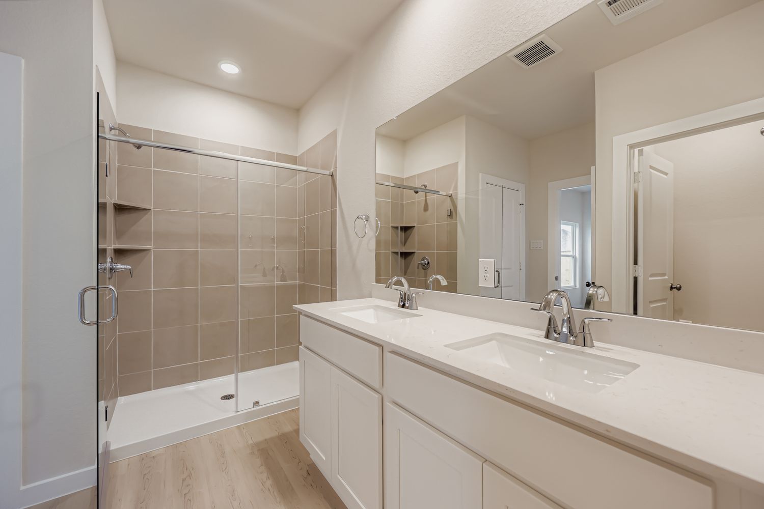 A bathroom with a large mirror.
