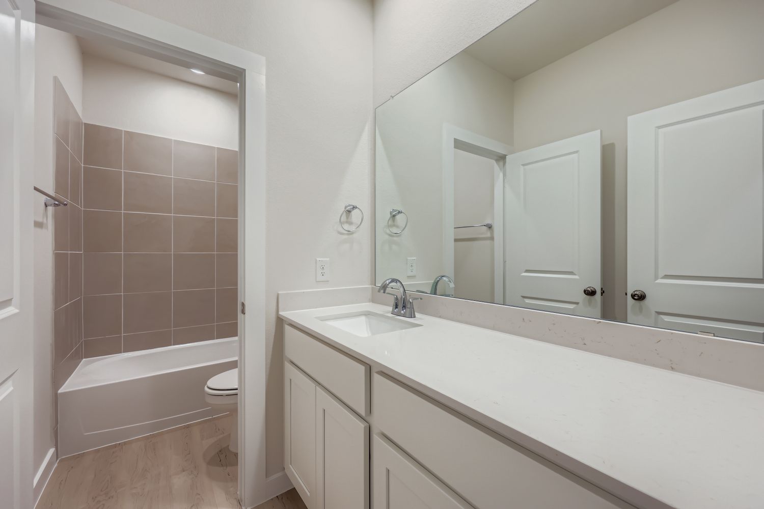 A bathroom with a tub sink and toilet.
