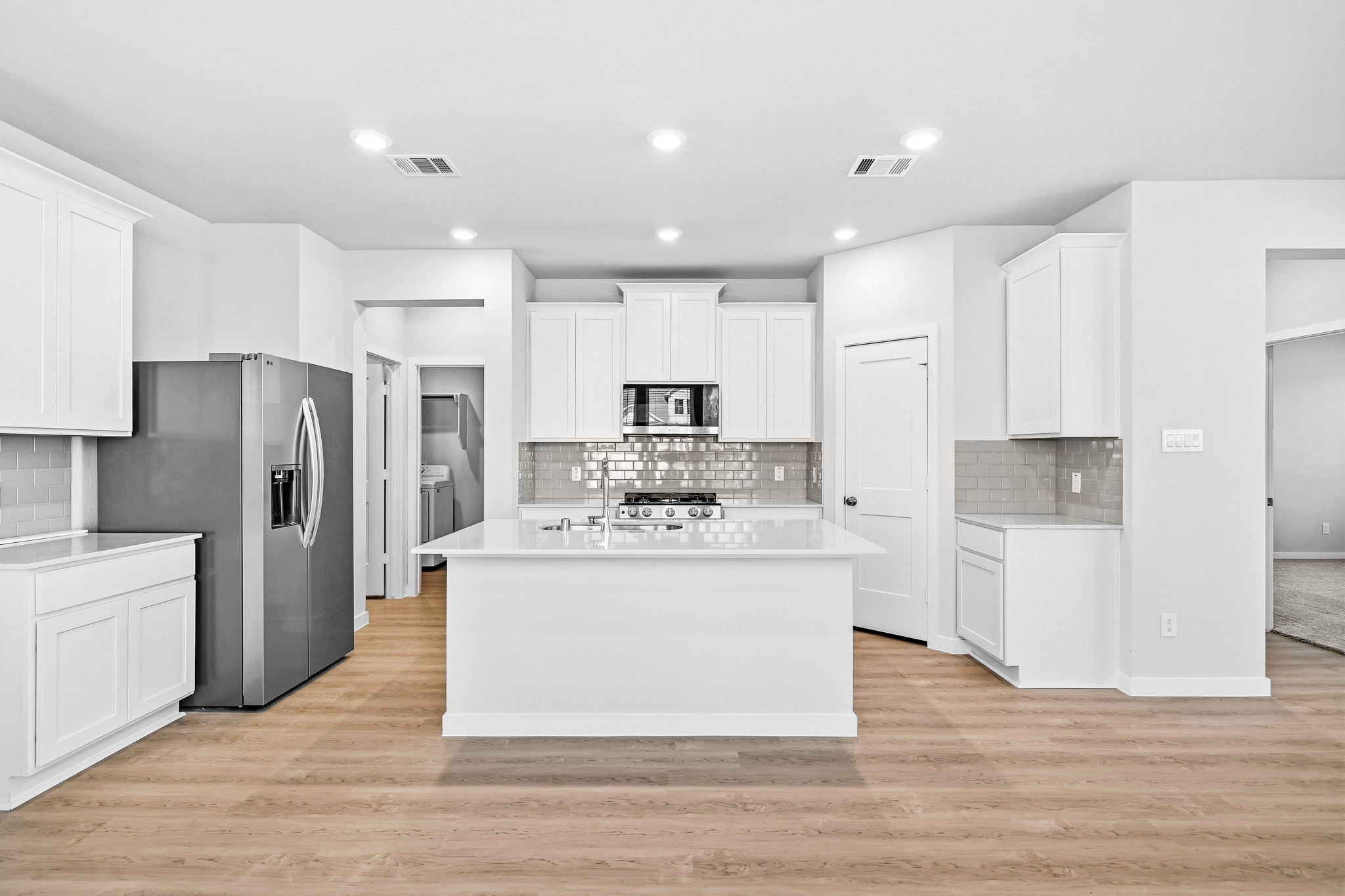 A kitchen with white cabinets.