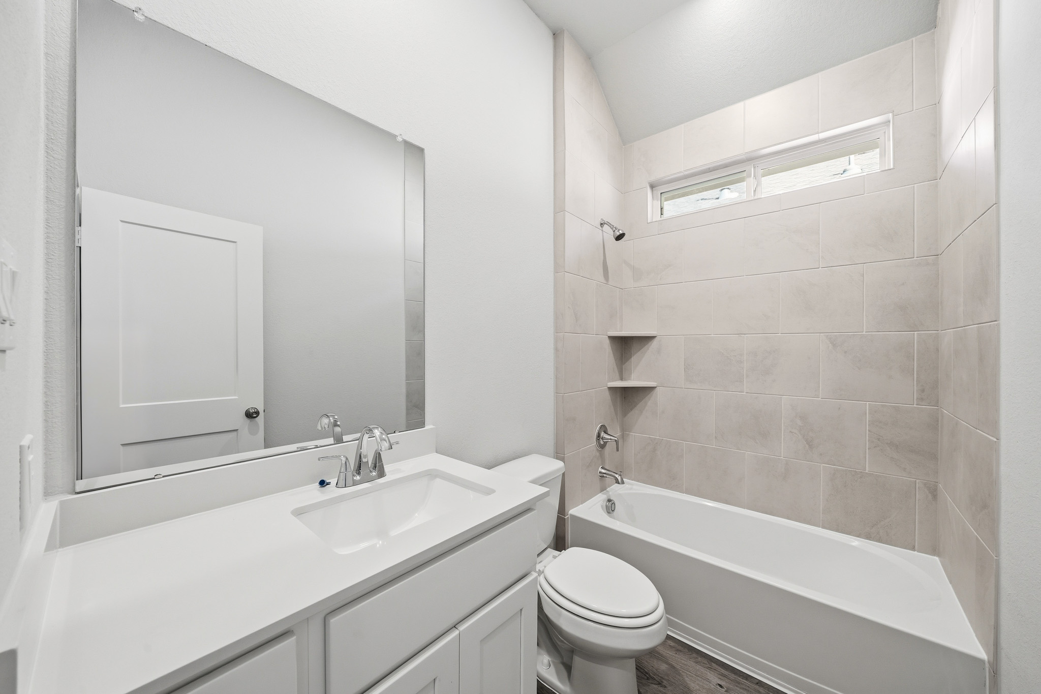 A bathroom with a tub sink and toilet.