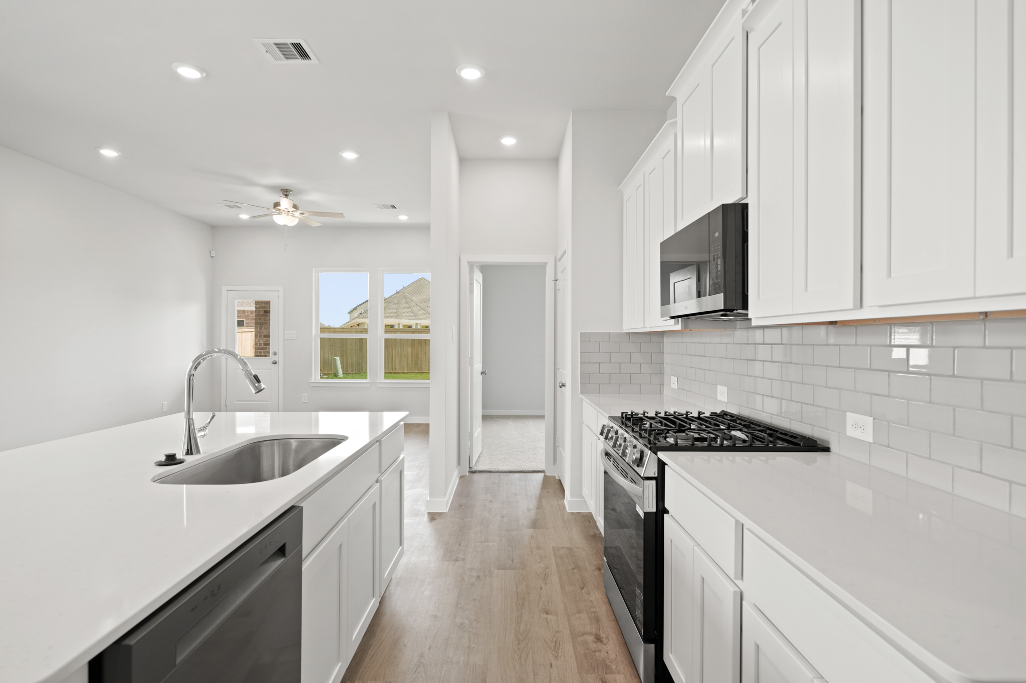 A kitchen with white cabinets.