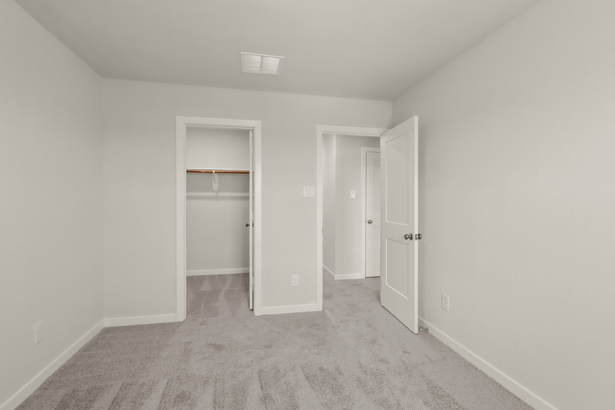 A hallway with white doors.