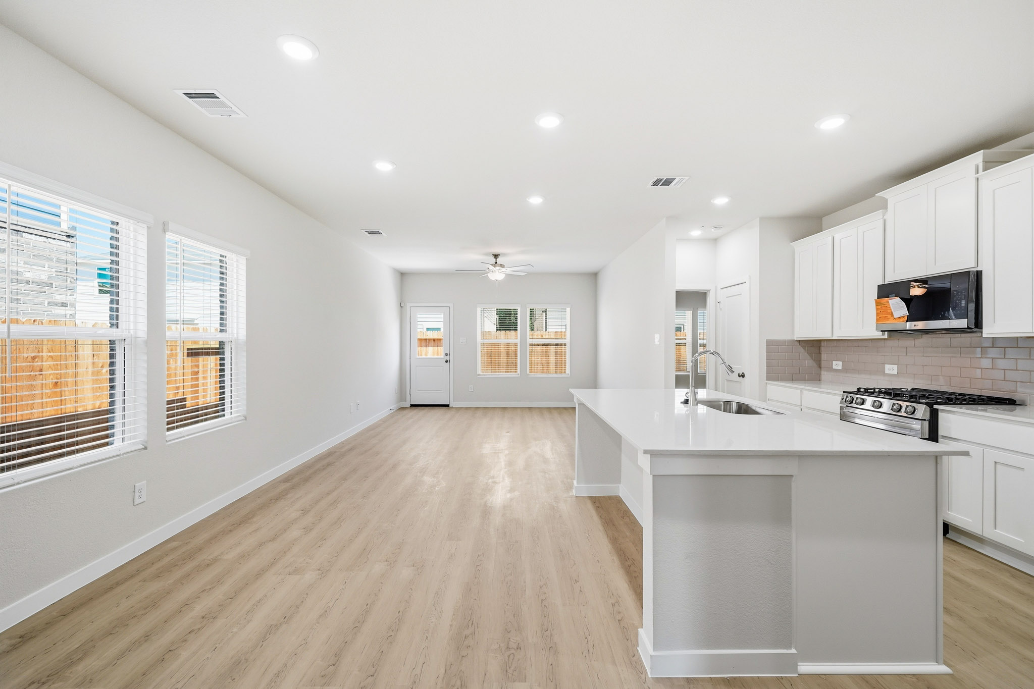 A kitchen with white cabinets.