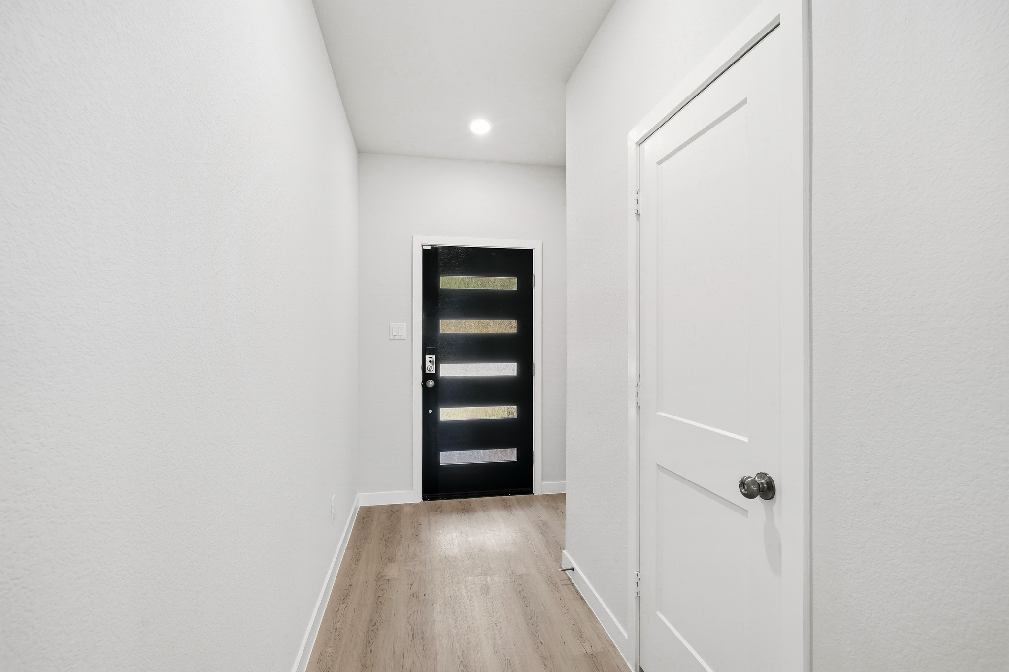 A hallway with white walls.