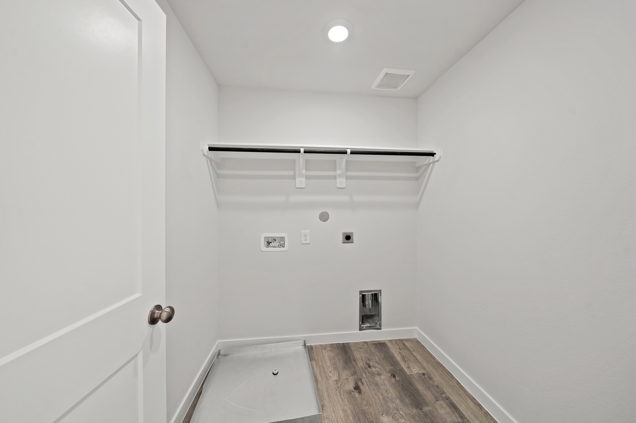 A bathroom with a tub and a shower unit.