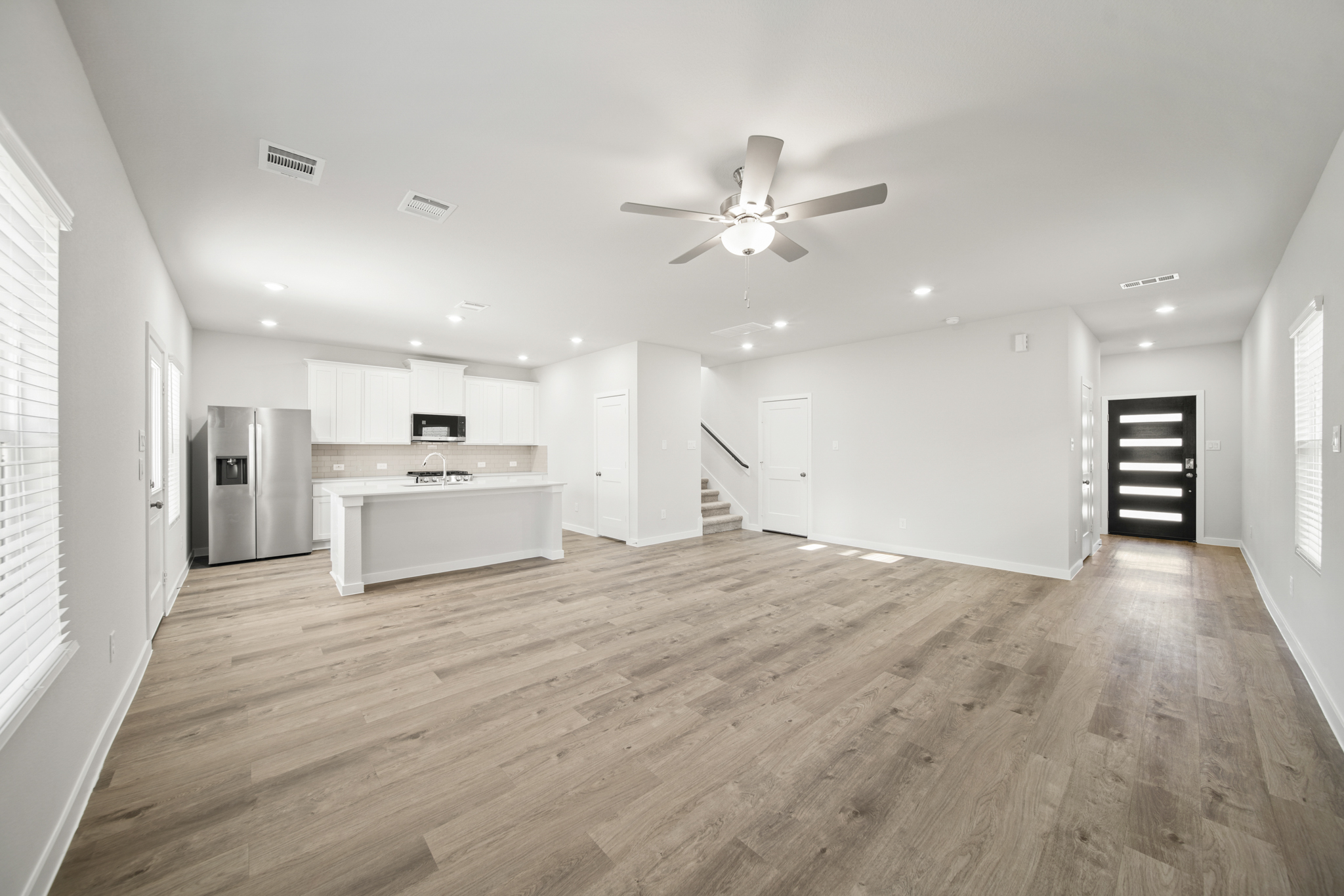 A large kitchen with white cabinets.