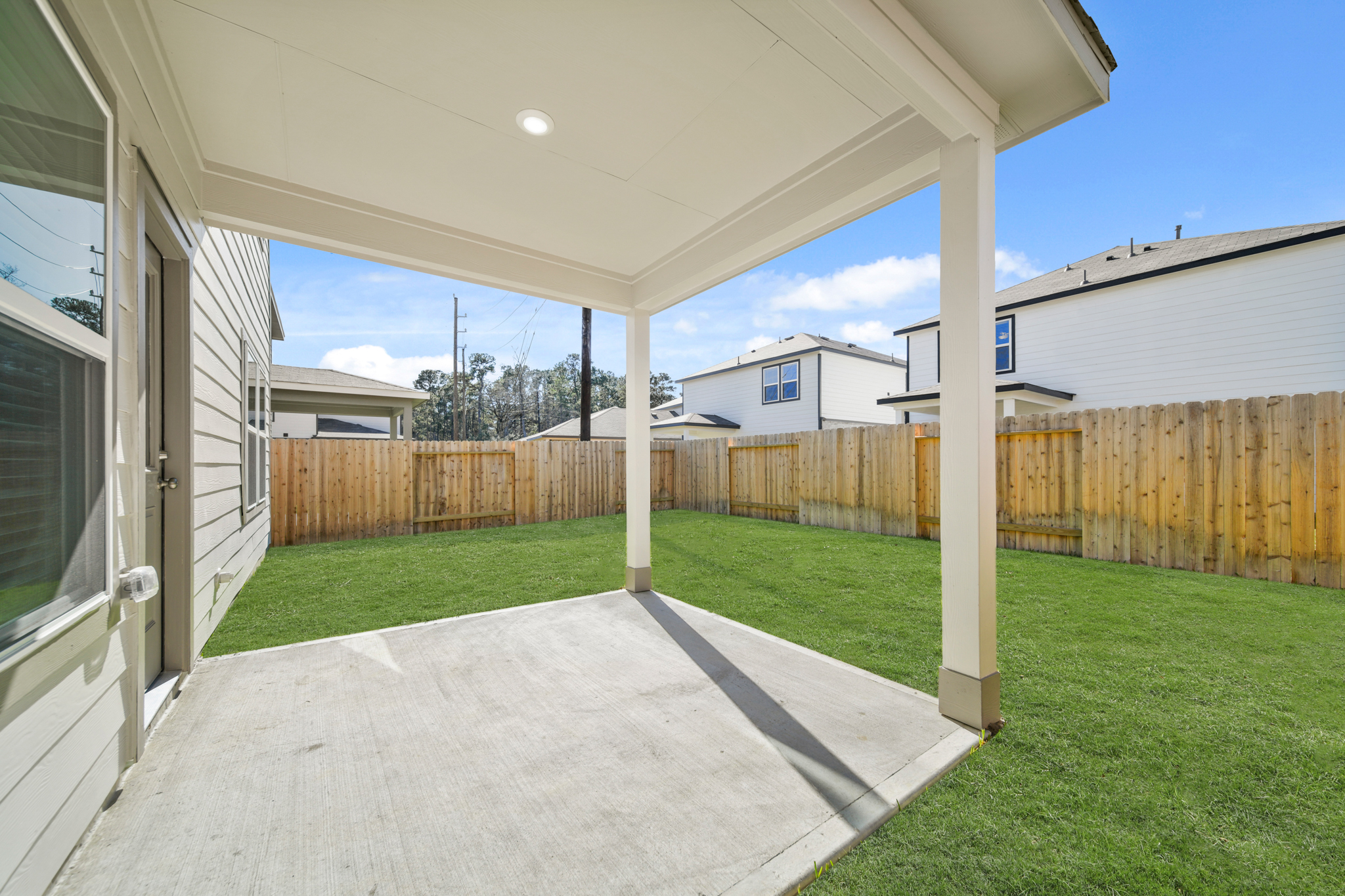 A backyard with a fence and a wood fence.