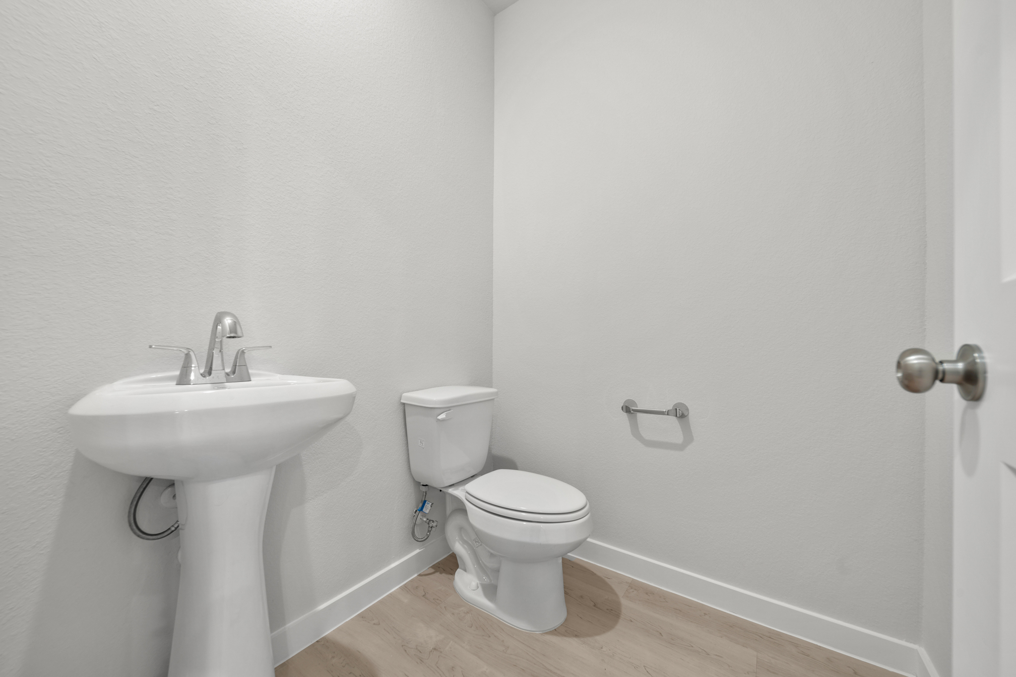 A bathroom with a toilet and sink.