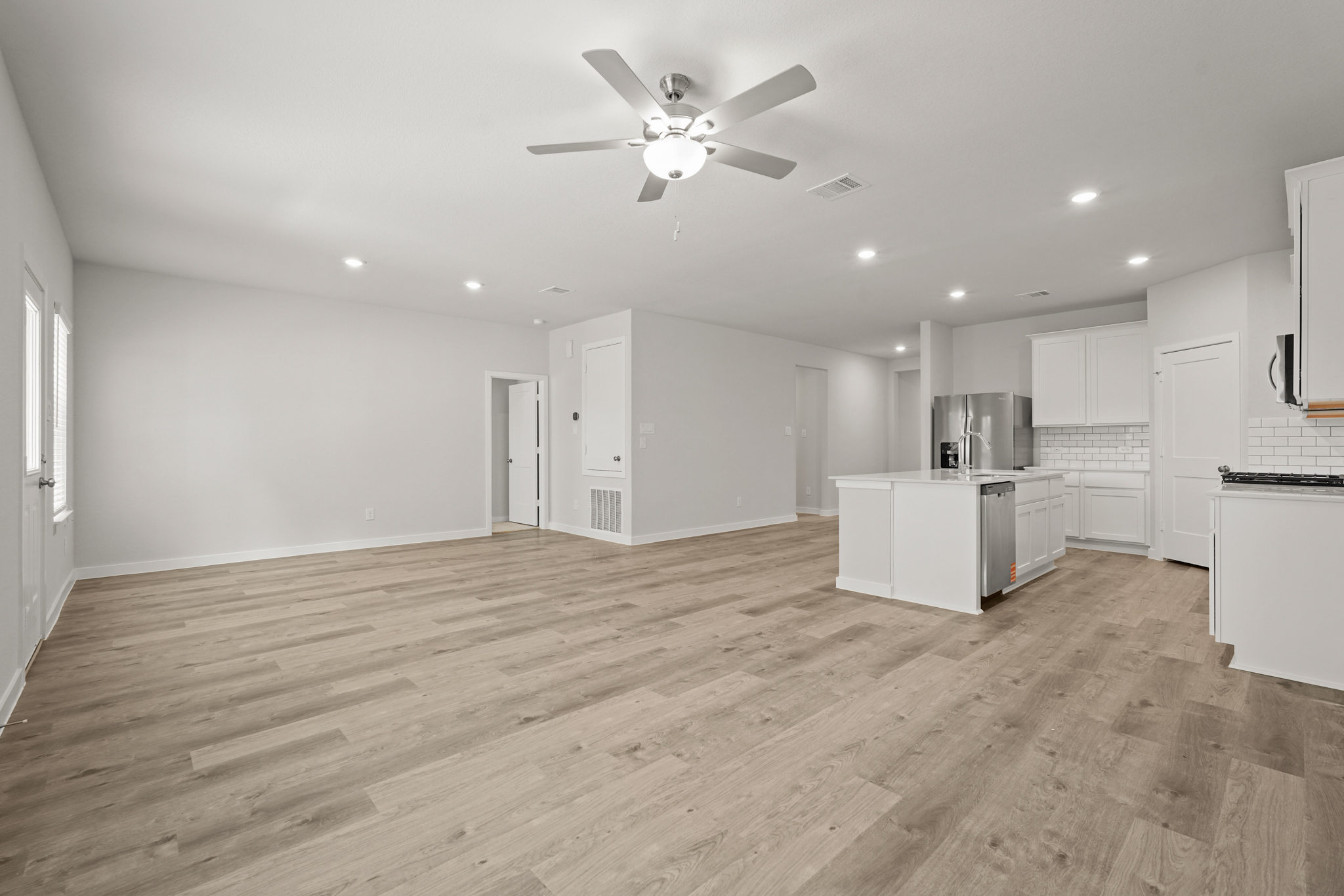 A large kitchen with white cabinets.
