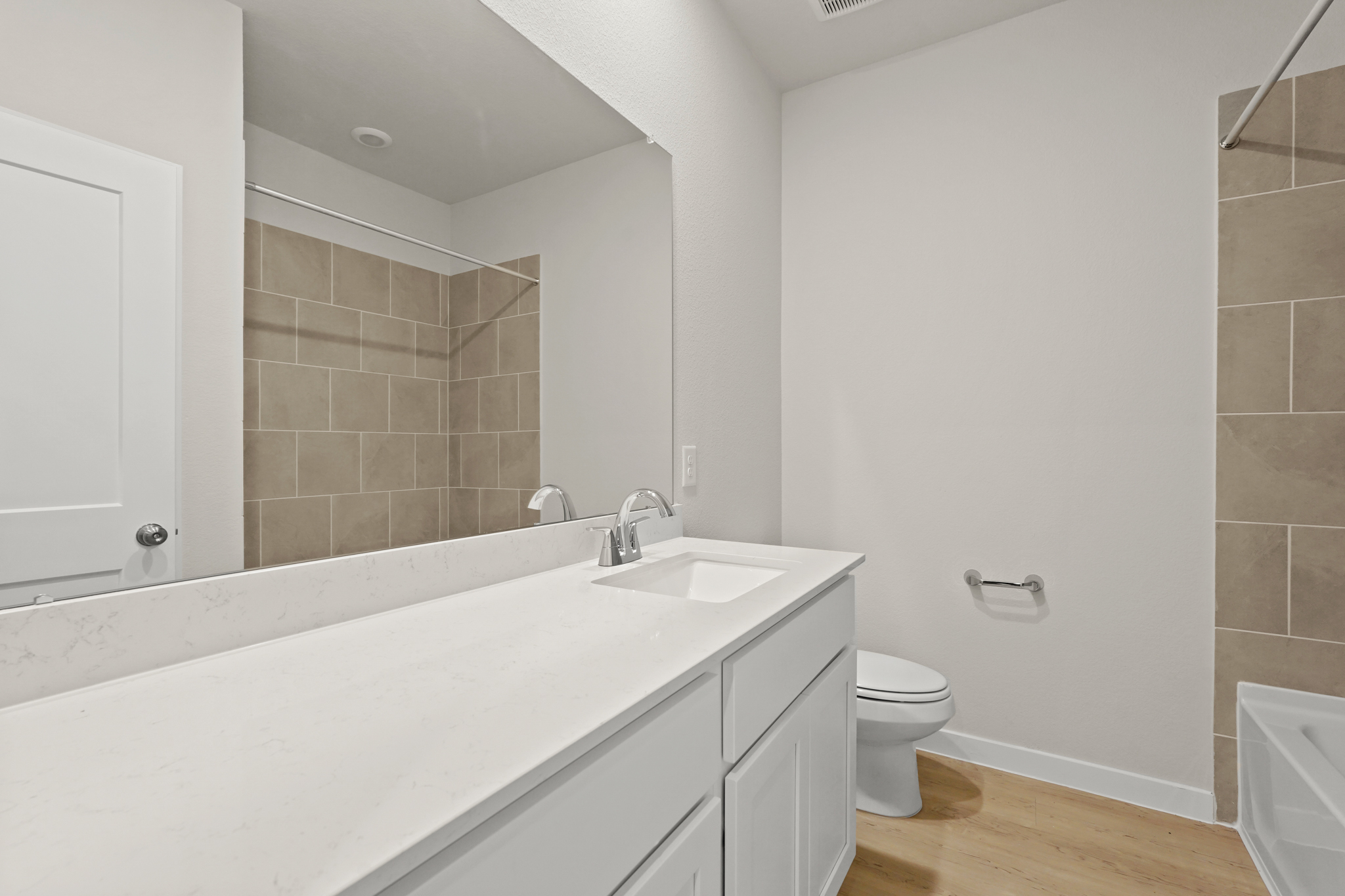 A bathroom with a tub sink and toilet.