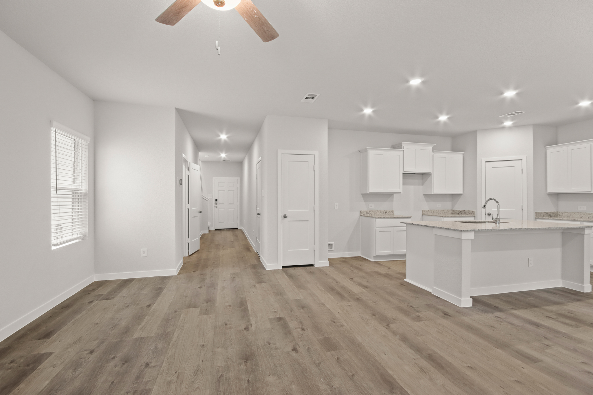 A large kitchen with white cabinets.