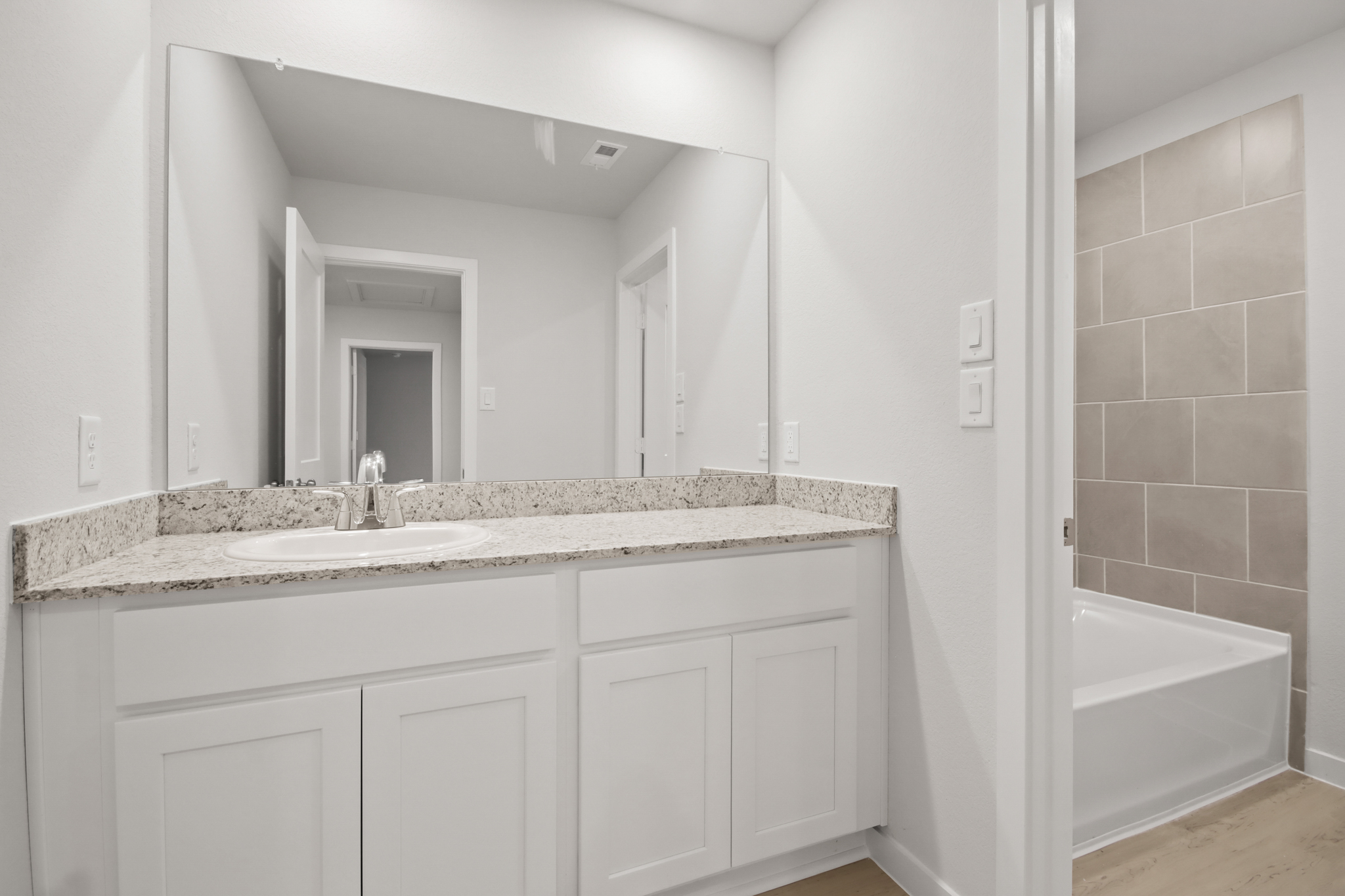 A bathroom with a marble countertop.