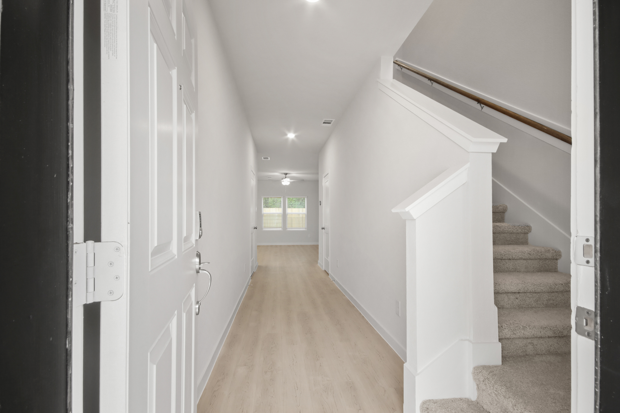 A hallway with white walls.