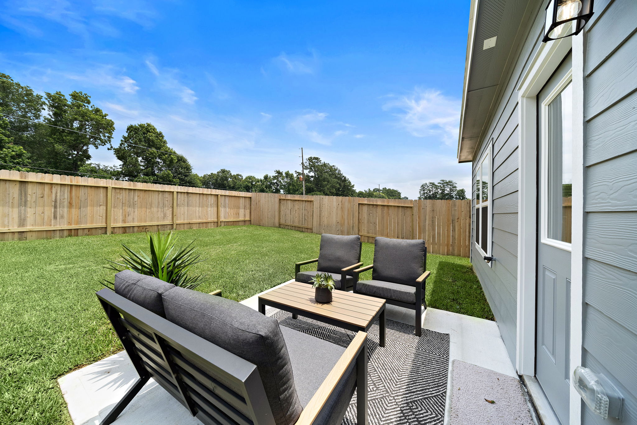 A patio with a table and chairs.