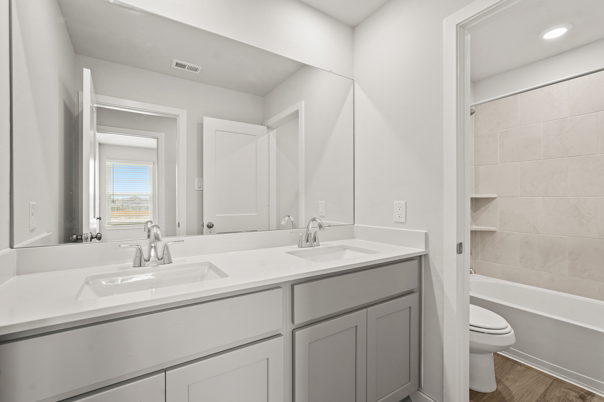 A bathroom with a tub sink and toilet.