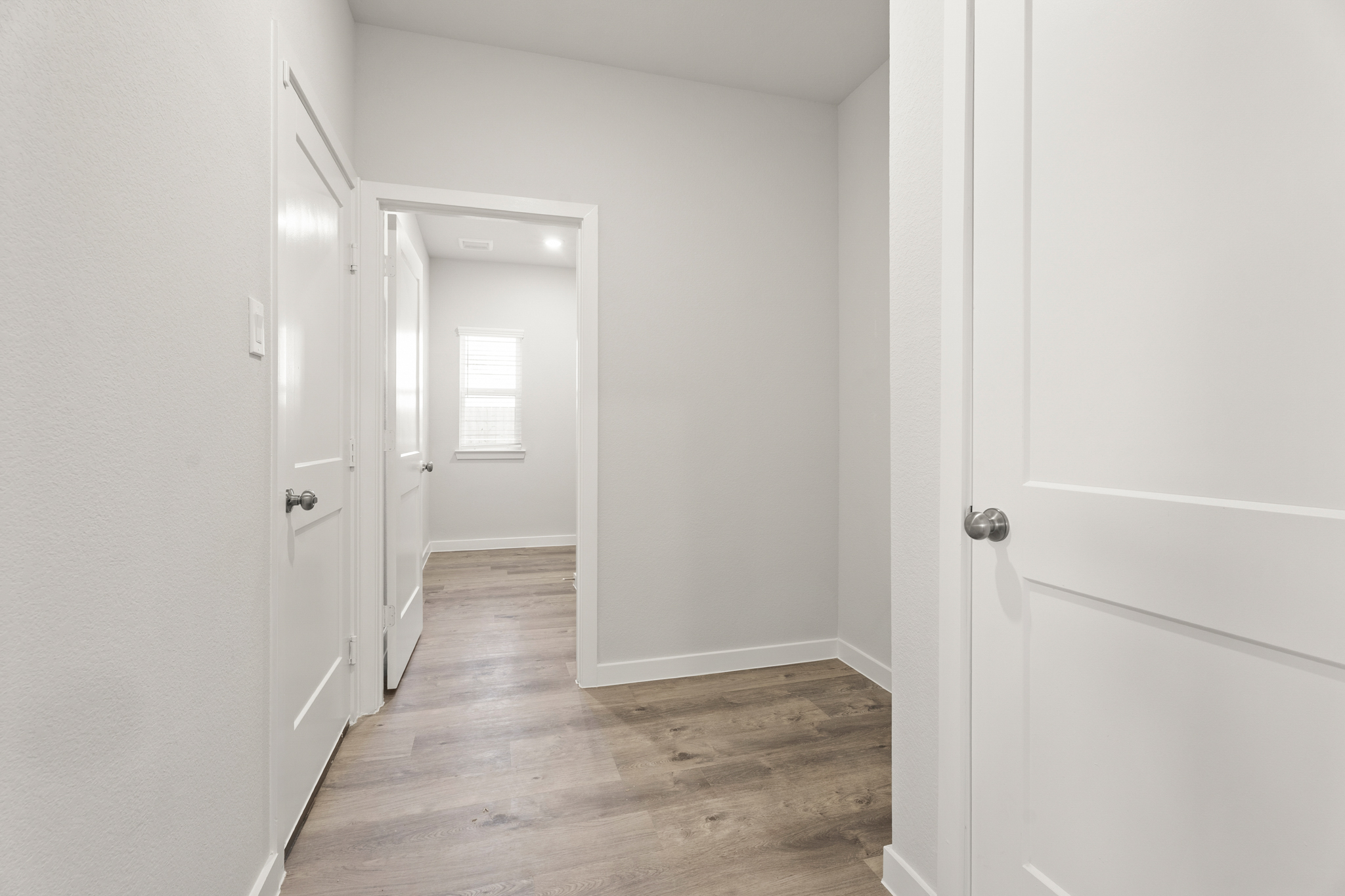 A hallway with white doors.