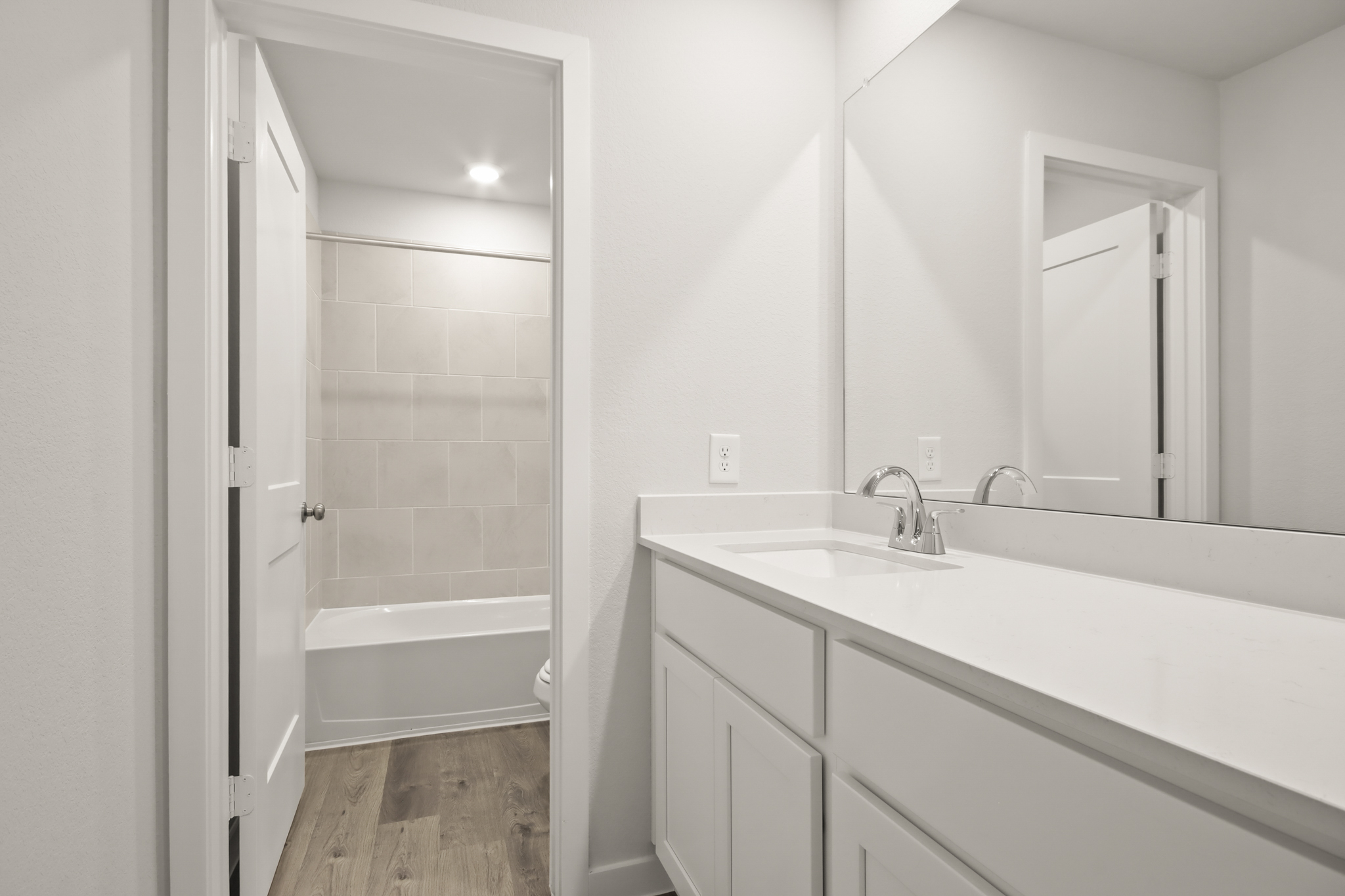 A bathroom with a tub sink and a shower.