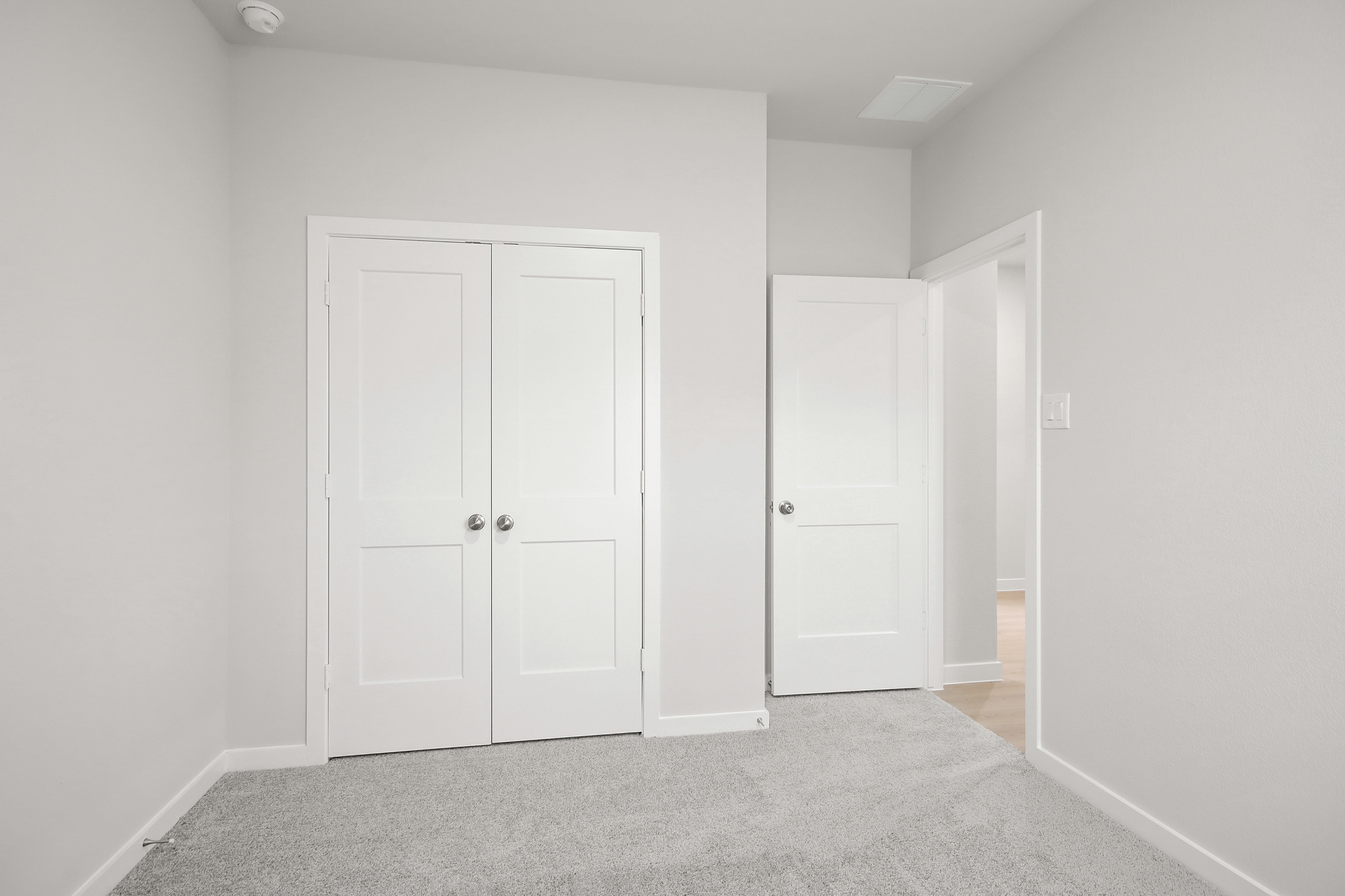 A hallway with white doors.