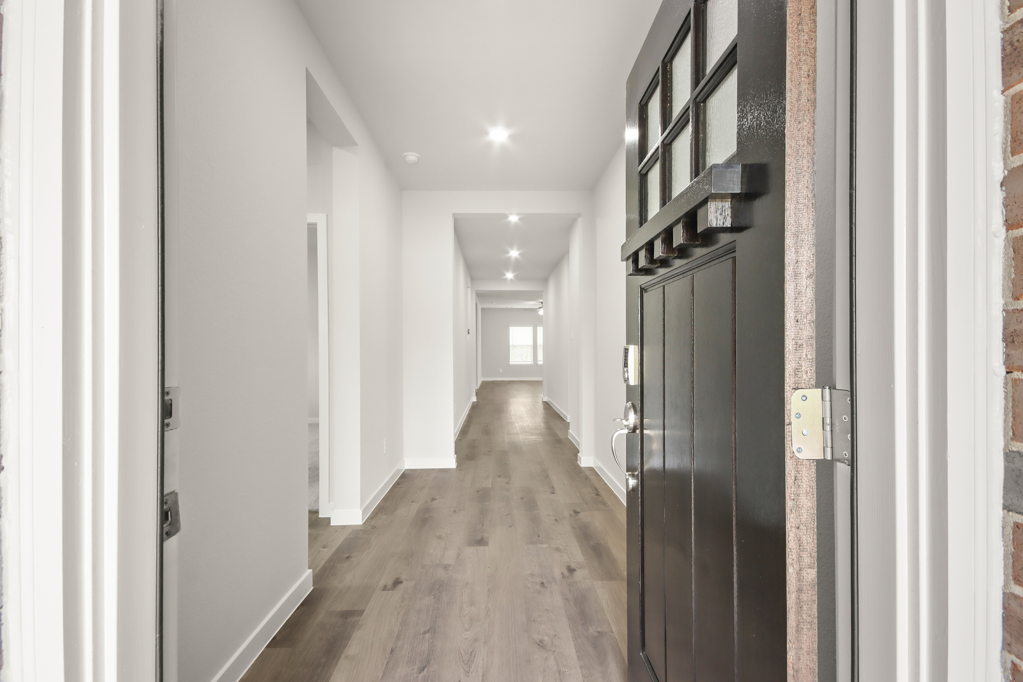 A hallway with black doors.