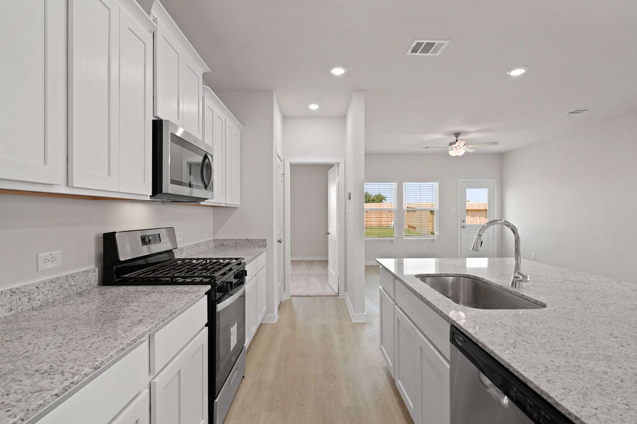 A kitchen with white cabinets.