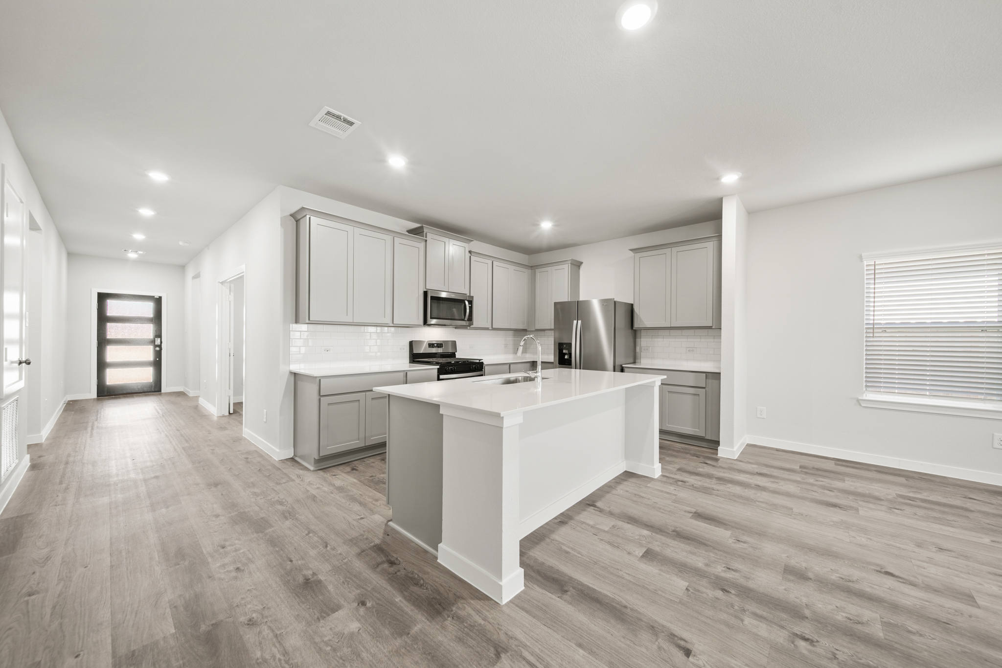 A kitchen with white cabinets.