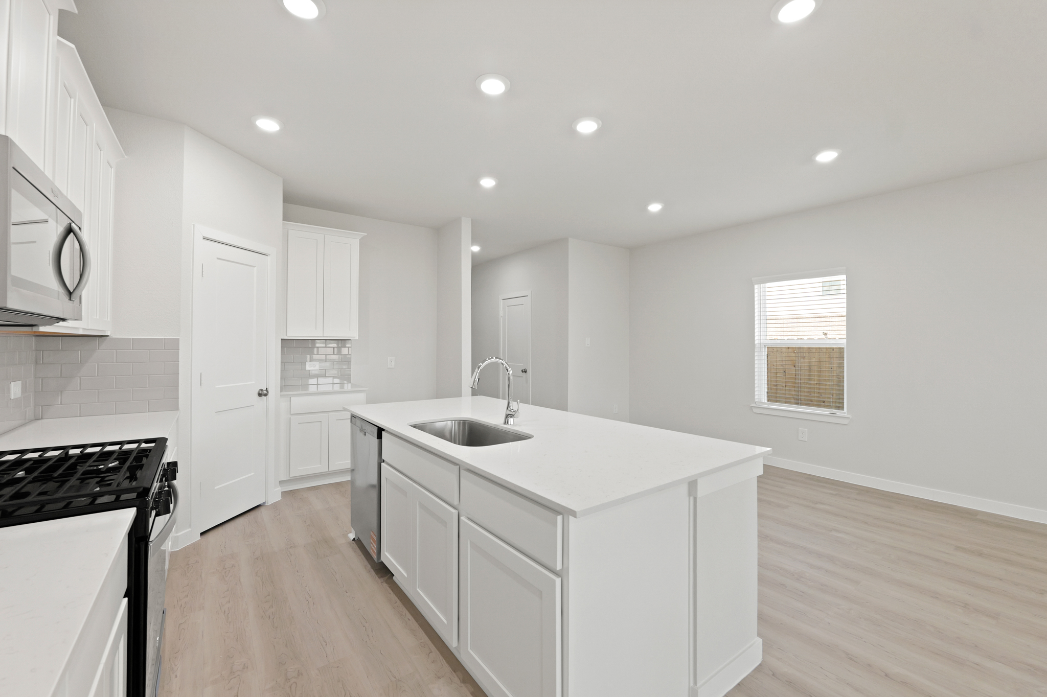 A kitchen with white cabinets.