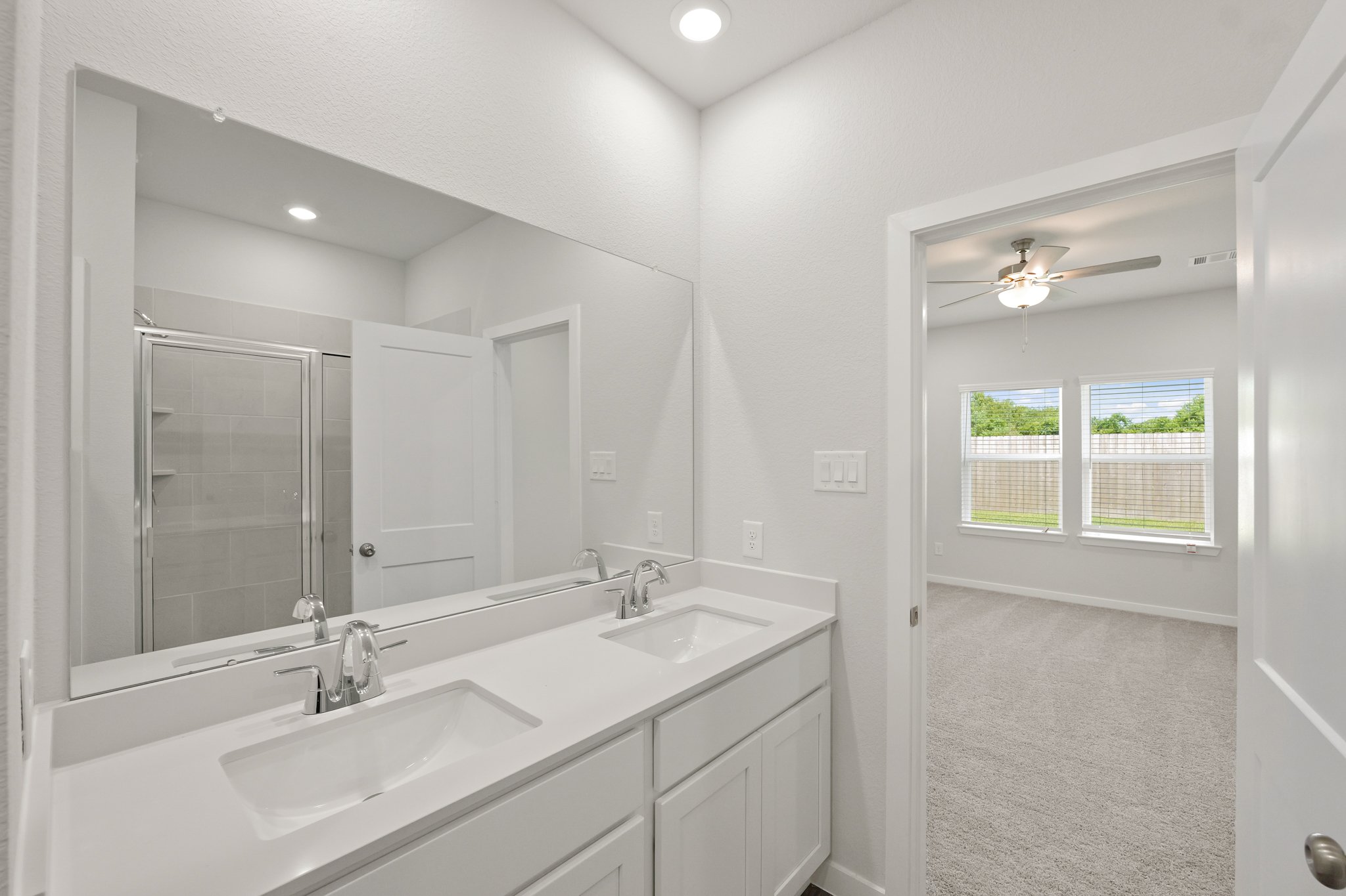 A bathroom with a large mirror.
