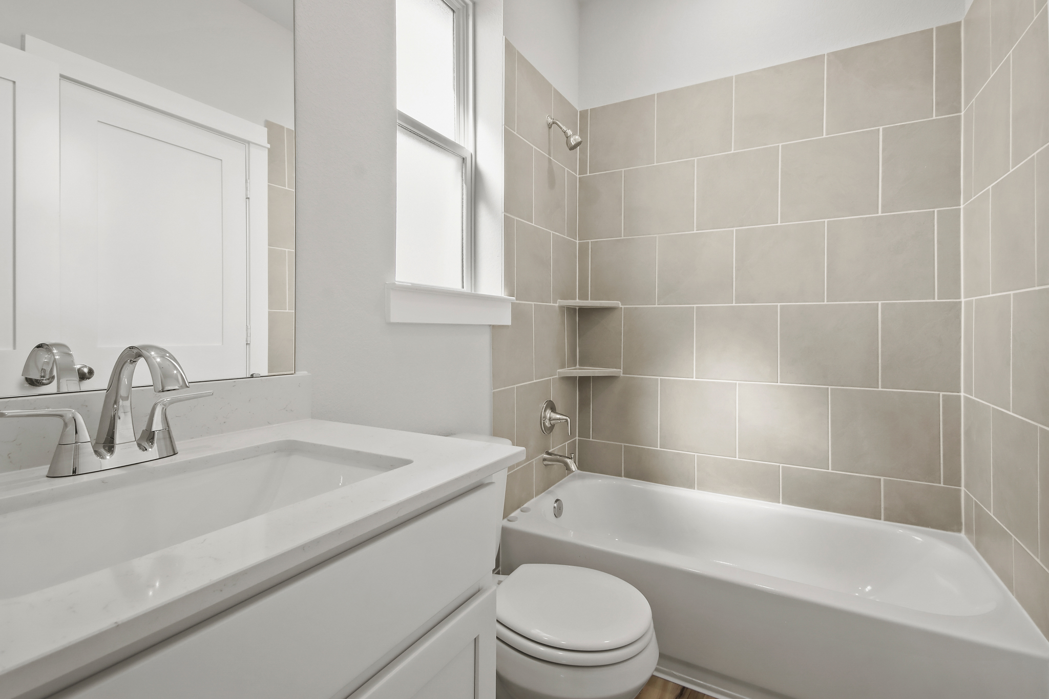 A bathroom with a tub sink and toilet.