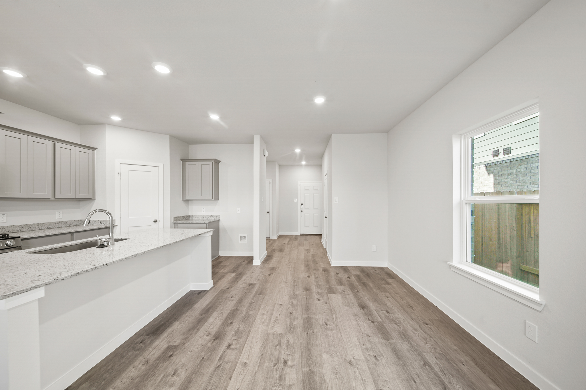 A large kitchen with white cabinets.