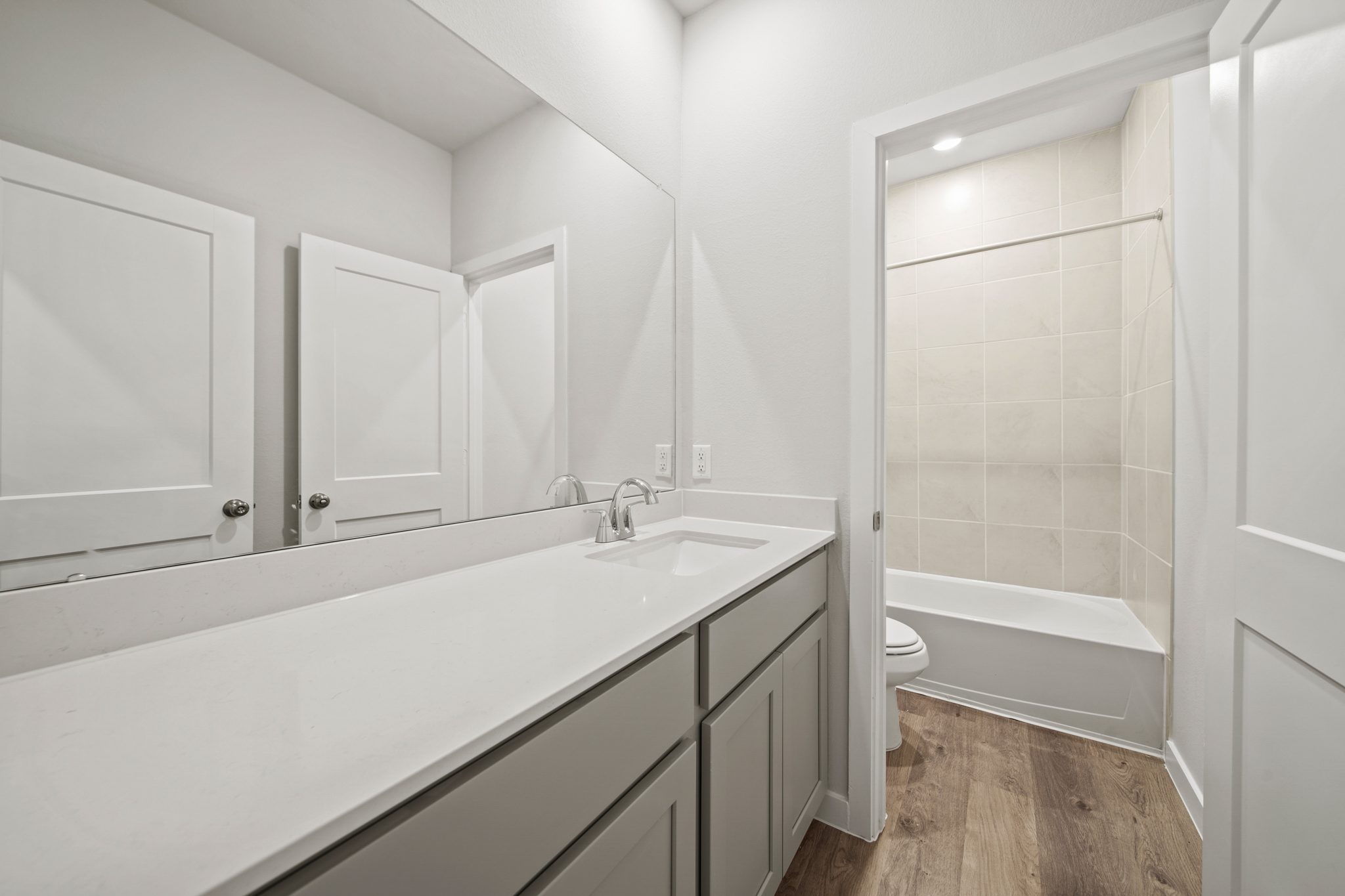 A bathroom with a tub sink and toilet.