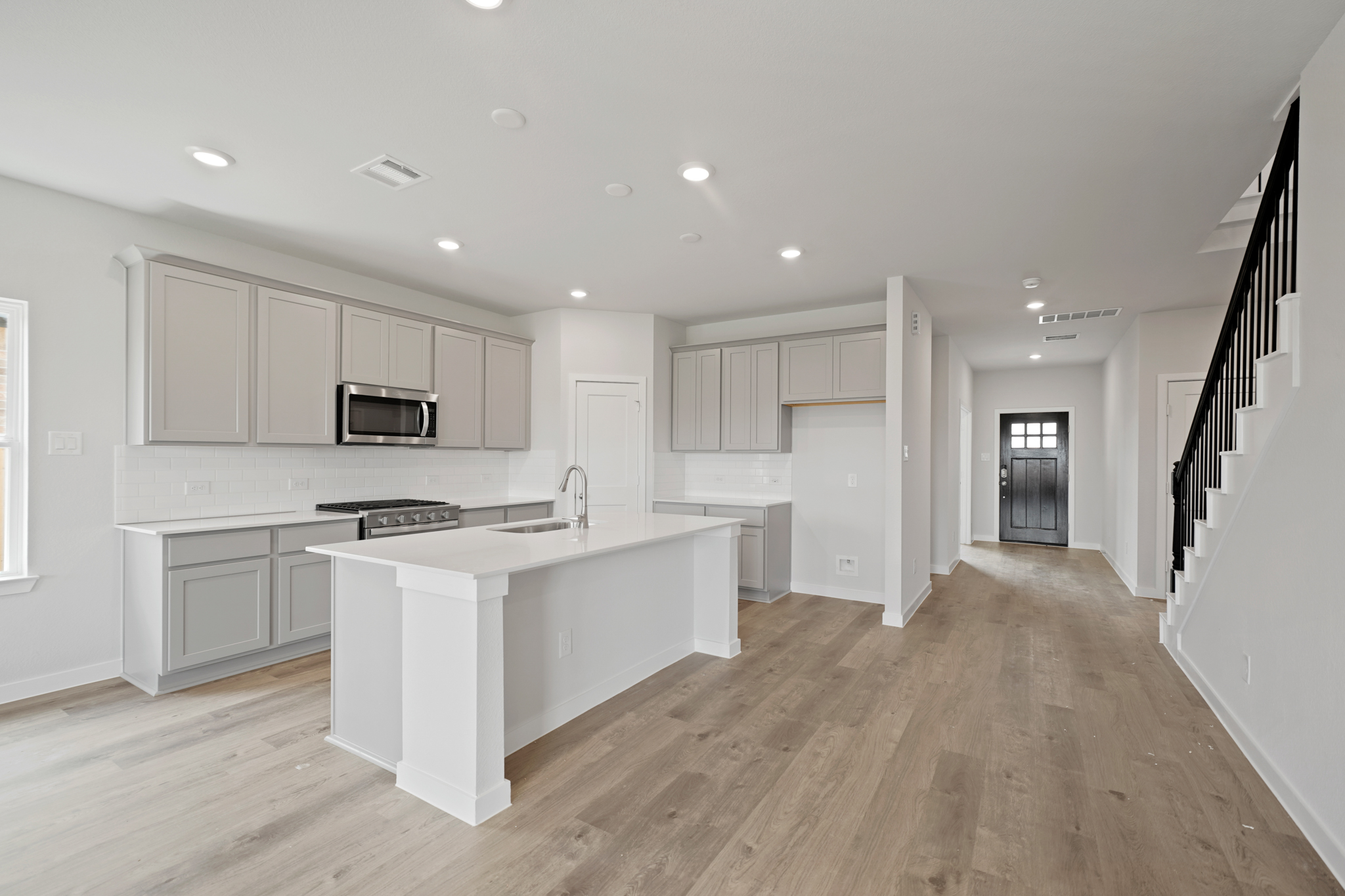 A kitchen with white cabinets.