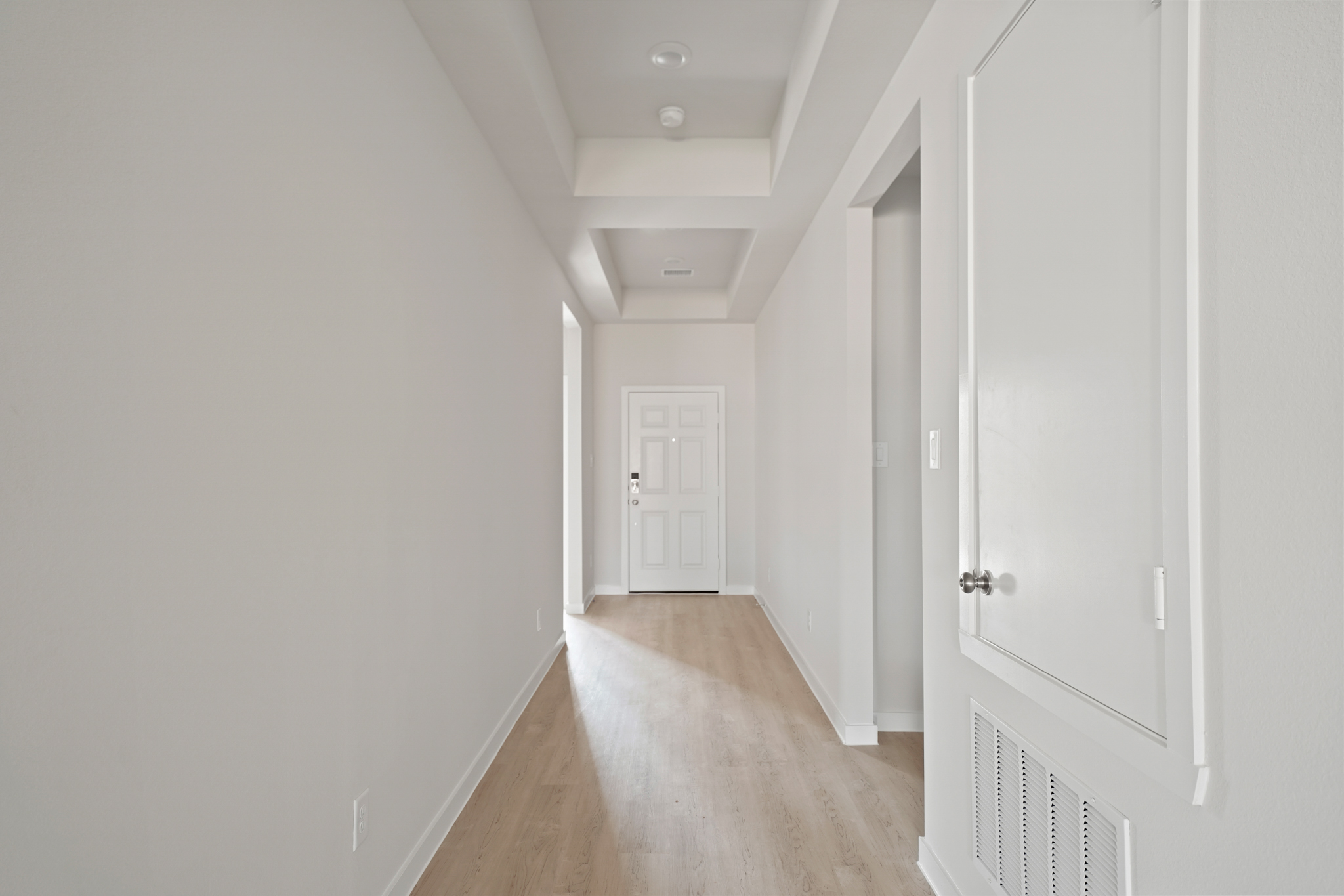 A hallway with white doors.