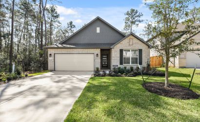 A house with a driveway and grass.