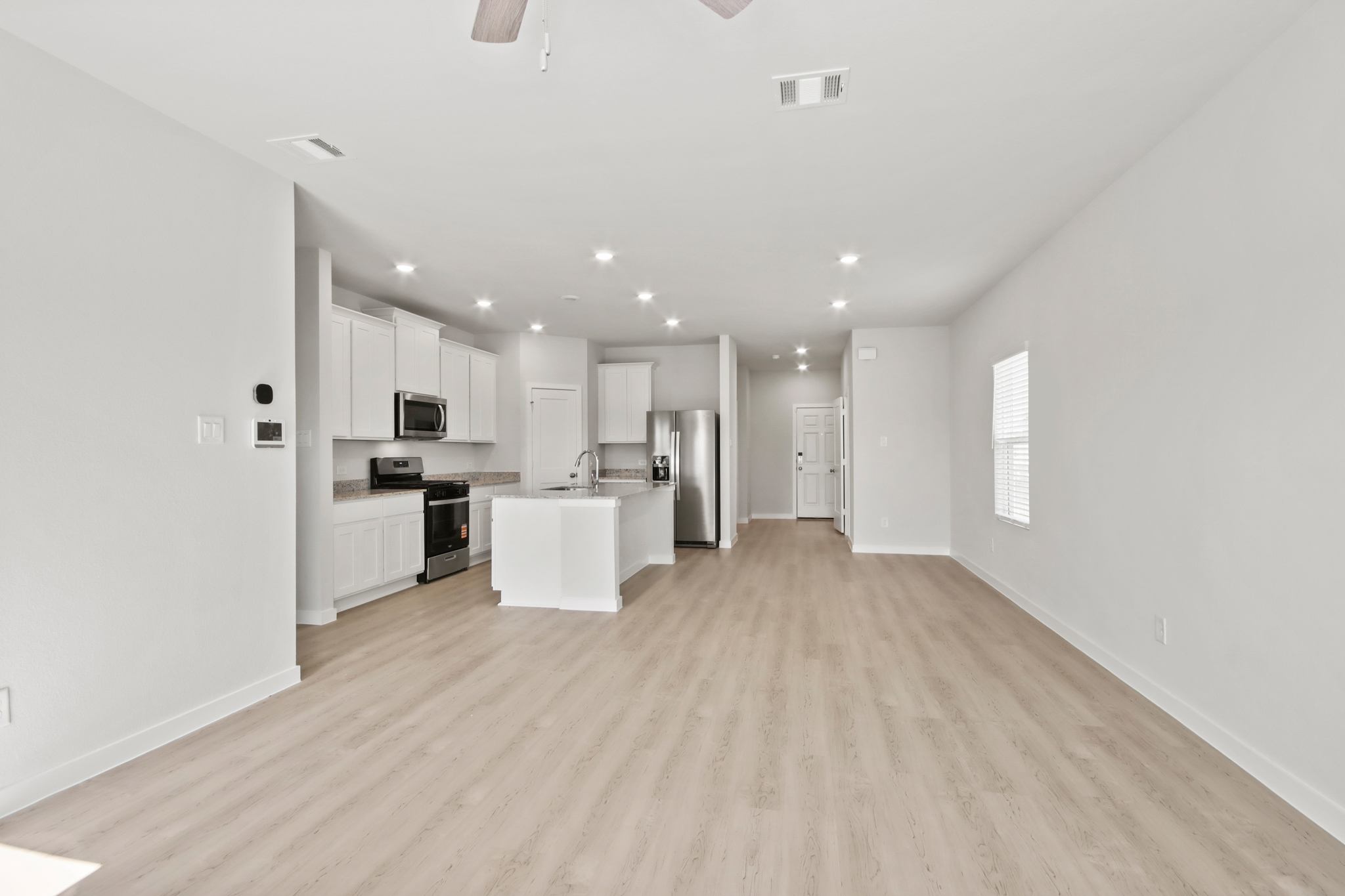 A large kitchen with white cabinets.