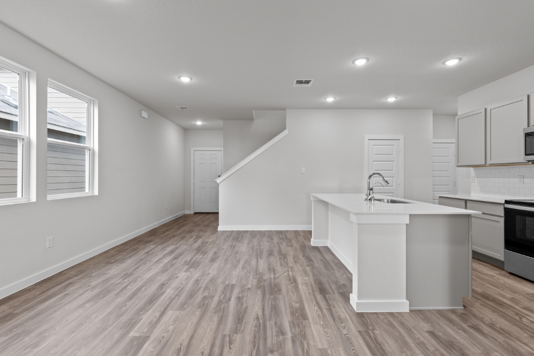 A kitchen with white cabinets.