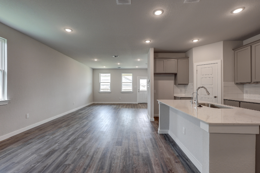 A kitchen with white cabinets.
