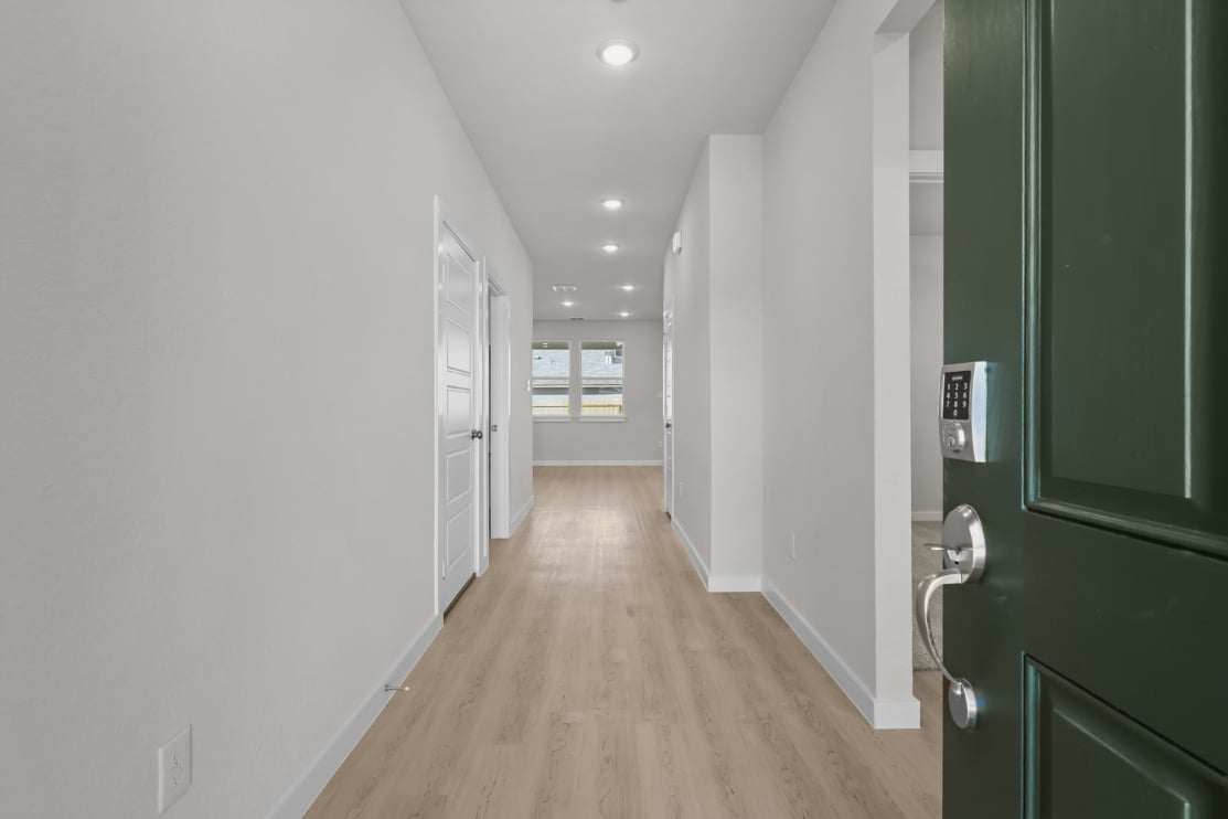 A hallway with green doors.