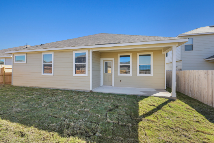 A house with a fence and grass.