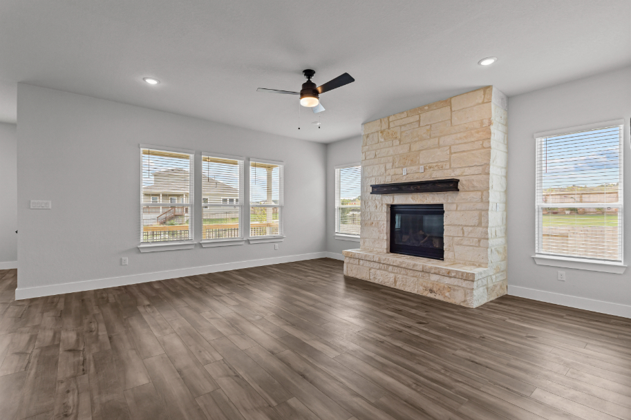 A room with a fireplace and a wood floor.