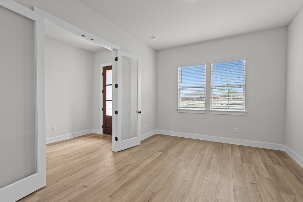 A room with a wood floor and white walls.