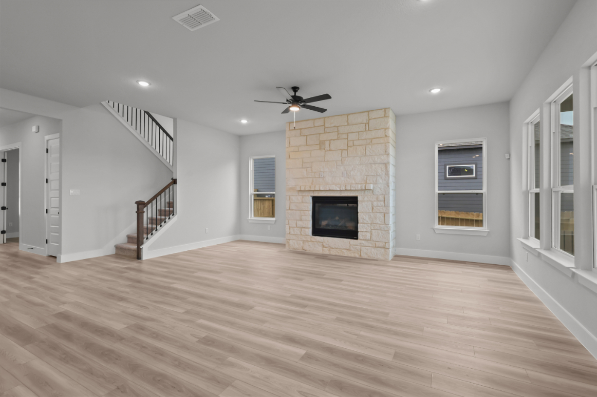A large living room with a fireplace.